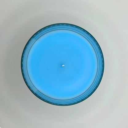 Bergamot Beach 220g candle, showing top view of wax, by Hellomelts, infused with refreshing bergamot, lily and a hint of coconut, in a beach-inspired blue wax.