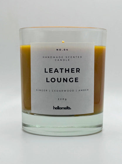 Leather Lounge 220g candle, with no lid, by Hellomelts, infused with notes of ginger, cedarwood, and amber, captured in a brown wax to resemble leather.