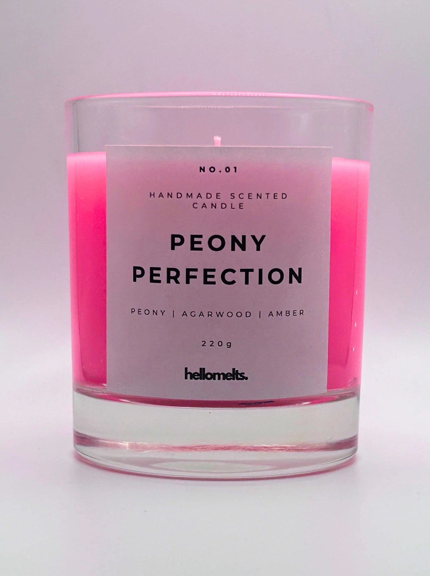 Peony Perfection 220g candle, with no lid, by Hellomelts, exuding delicate peony, luxurious agarwood, and warm amber aromas, in a beautiful bright pink wax.