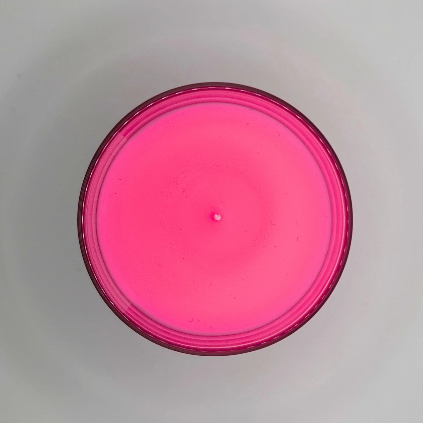 Peony Perfection 220g candle, showing top view of wax, by Hellomelts, exuding delicate peony, luxurious agarwood, and warm amber aromas, in a beautiful bright pink wax.