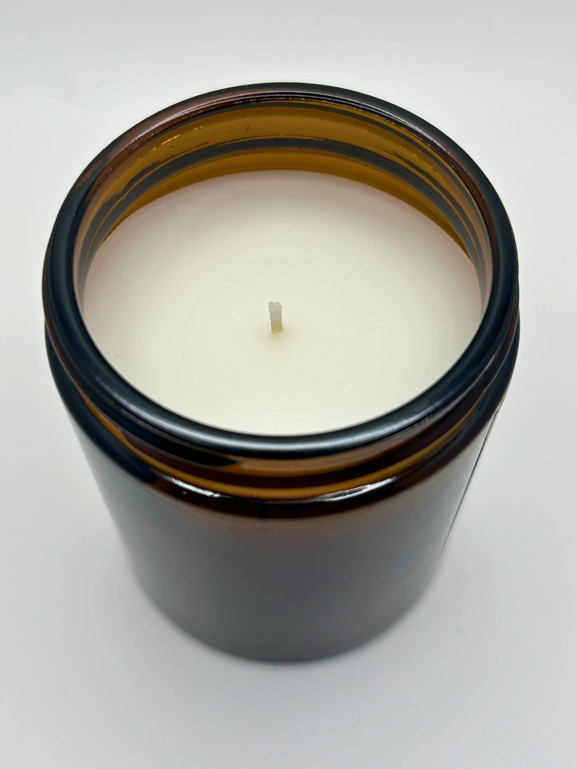 Angled top view of Cedarwood & Amber candle by Hellomelts, part of the autumn collection, highlighting the hand-poured wax.