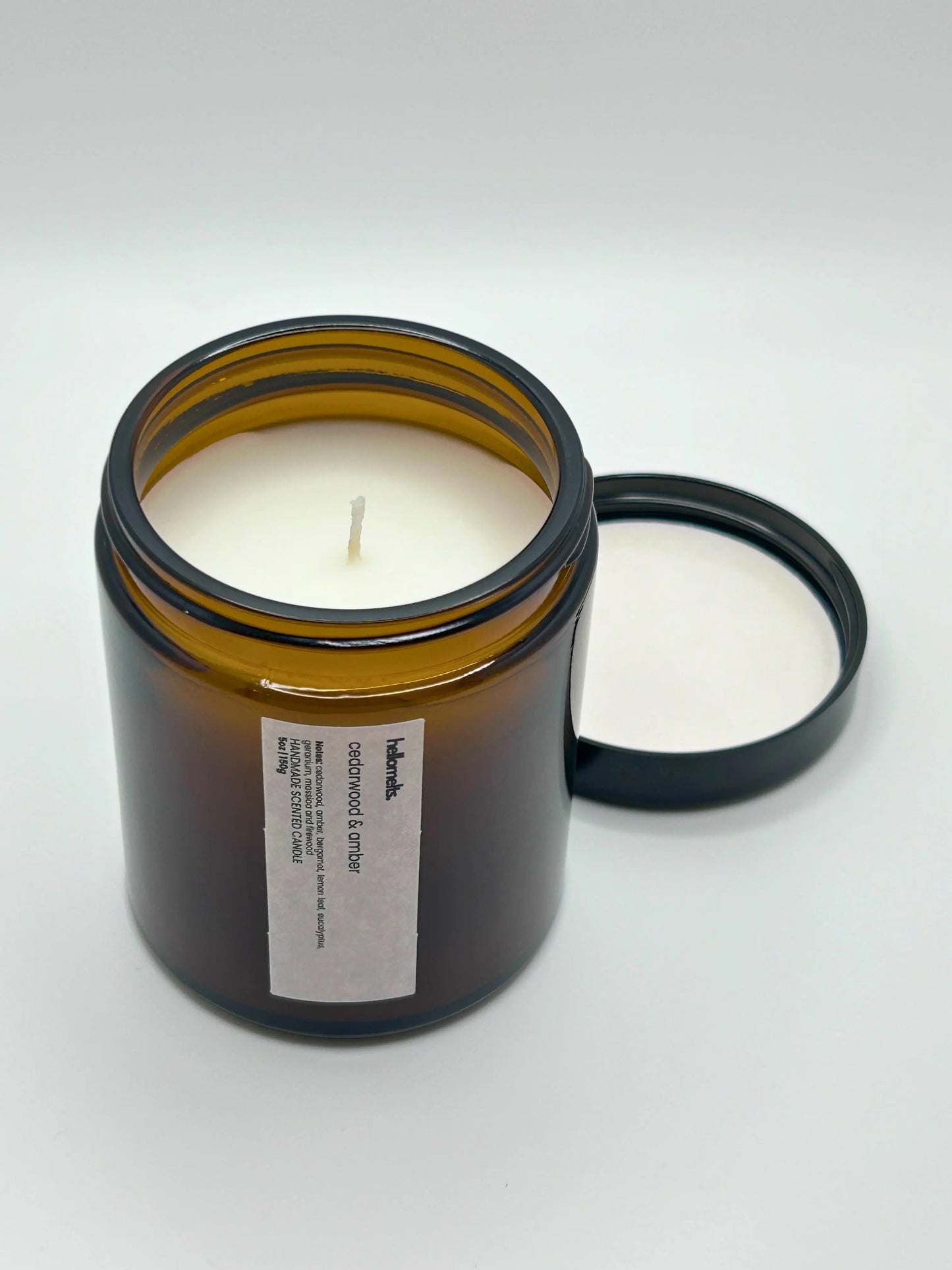 Angled view of Cedarwood & Amber candle by Hellomelts, showcasing the amber jar from the autumn collection.