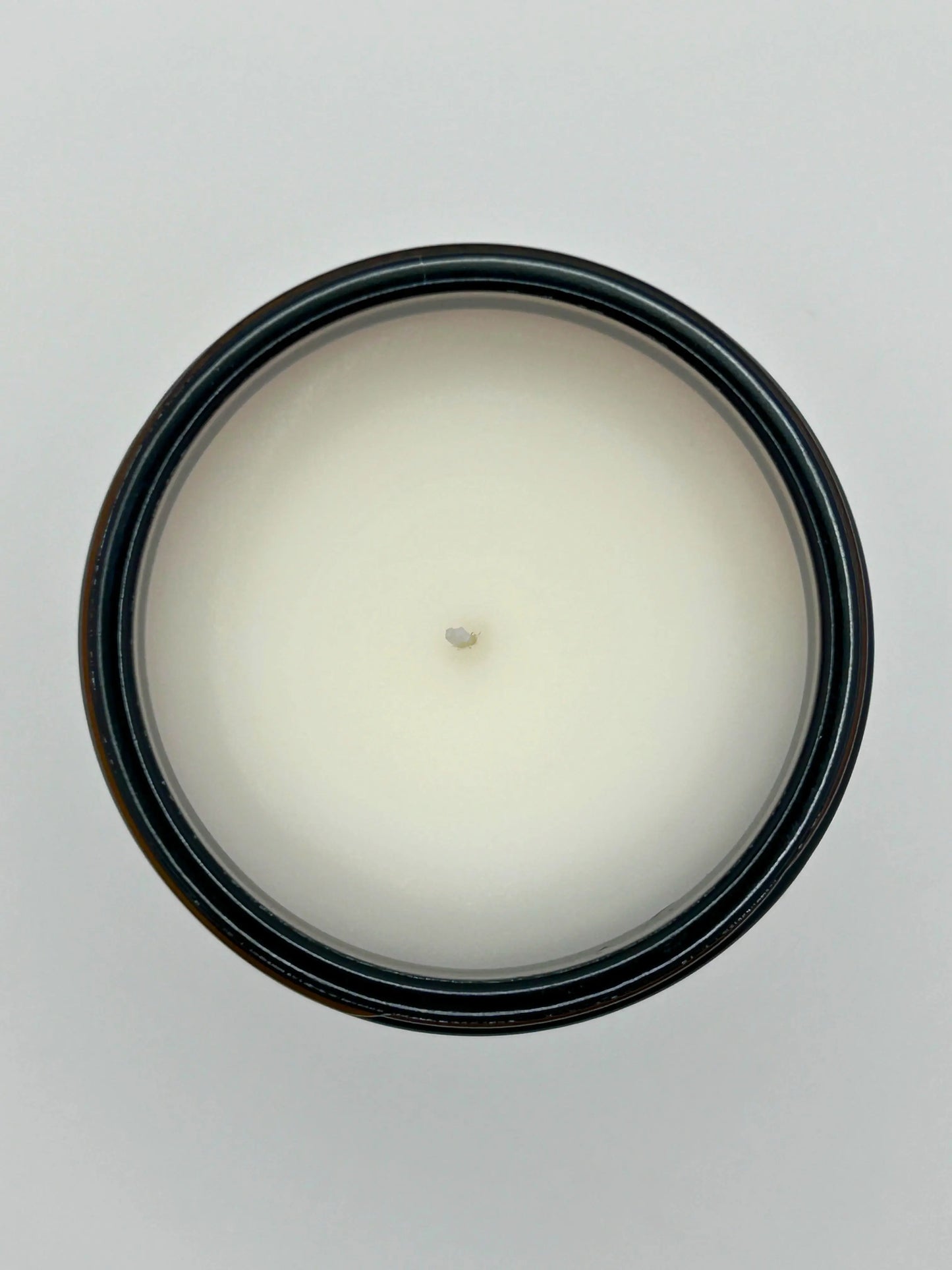 Top view of Cedarwood & Amber candle from Hellomelts, showing the hand-poured wax in an amber jar from the autumn collection.