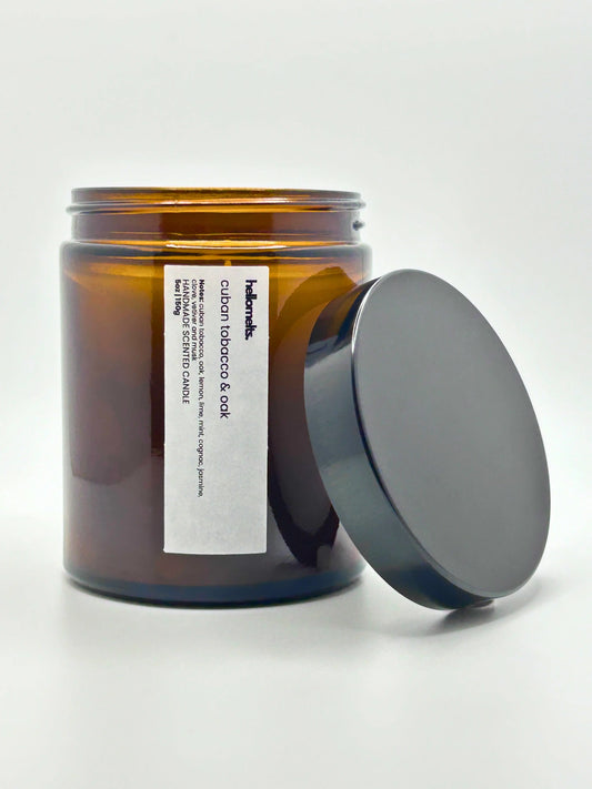 Front view of Cuban Tobacco & Oak candle by Hellomelts with the lid placed beside it, part of the autumn collection.